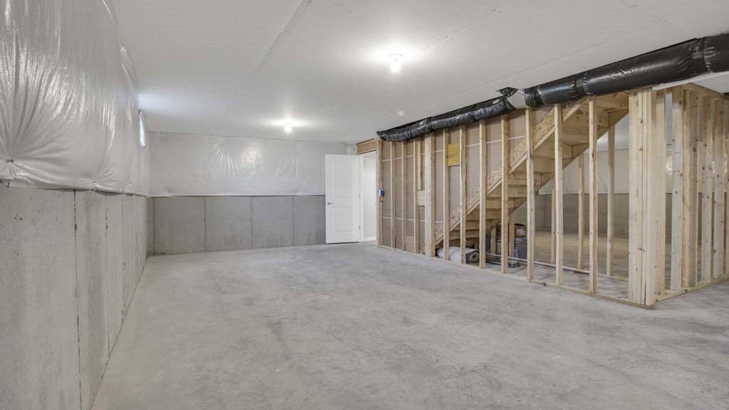 Basement showing entry way from stairs and framing.