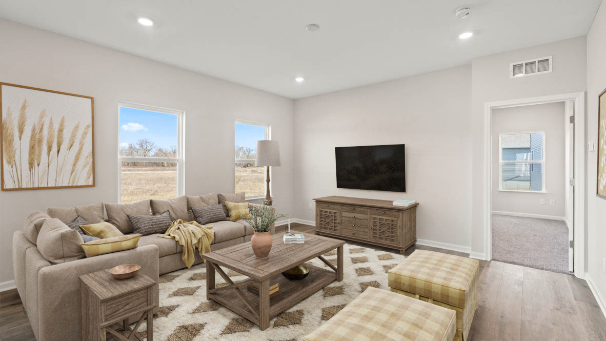 Living room with modern furniture and large windows.