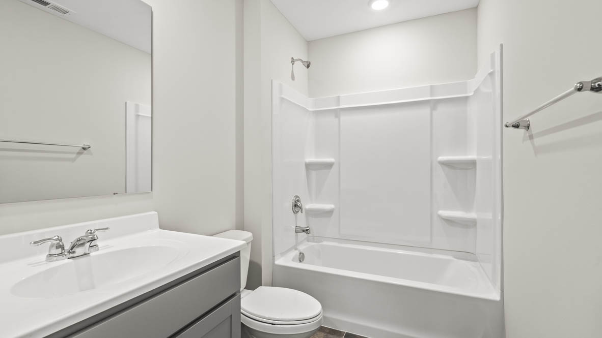 Bathroom with sink, mirror, toilet, and tub