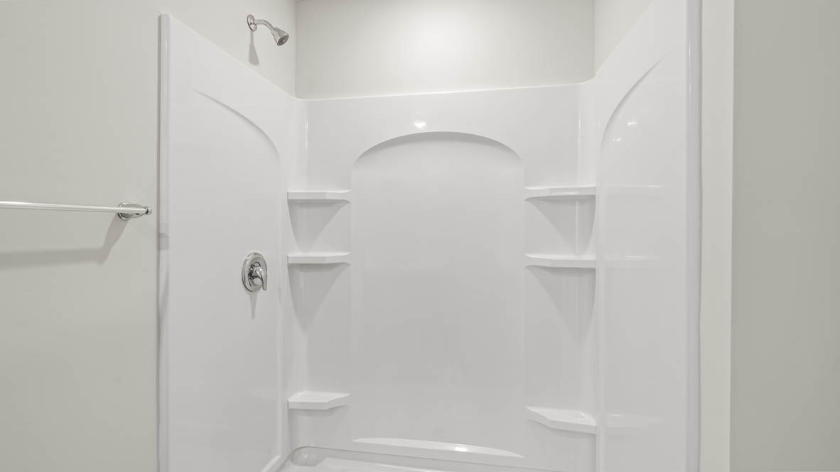Closeup of walk-in shower with tiered shelving