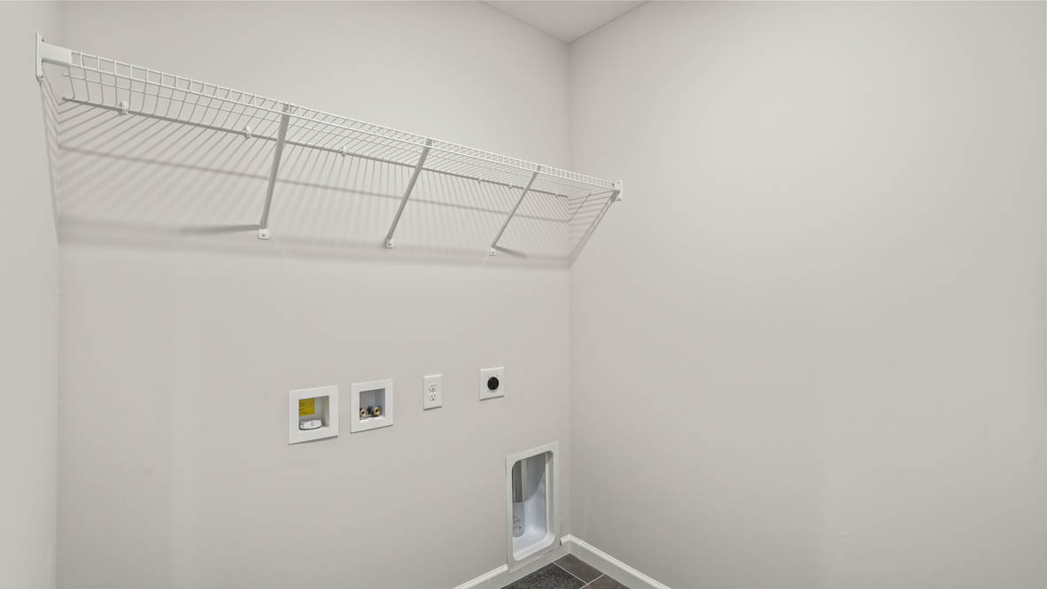 Laundry area with washer/dryer inlets and wire rack shelf