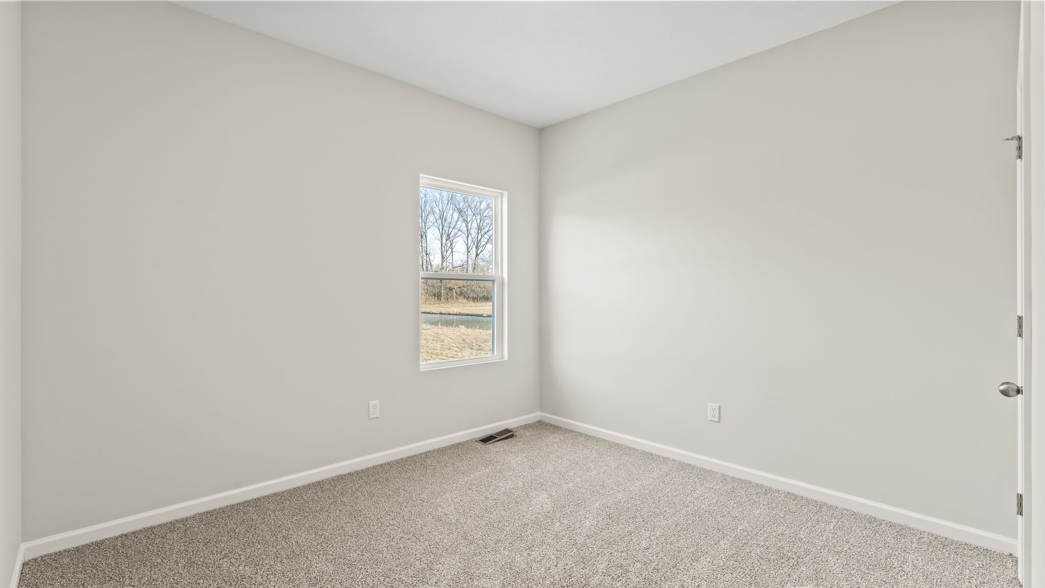 Carpeted bedroom with window