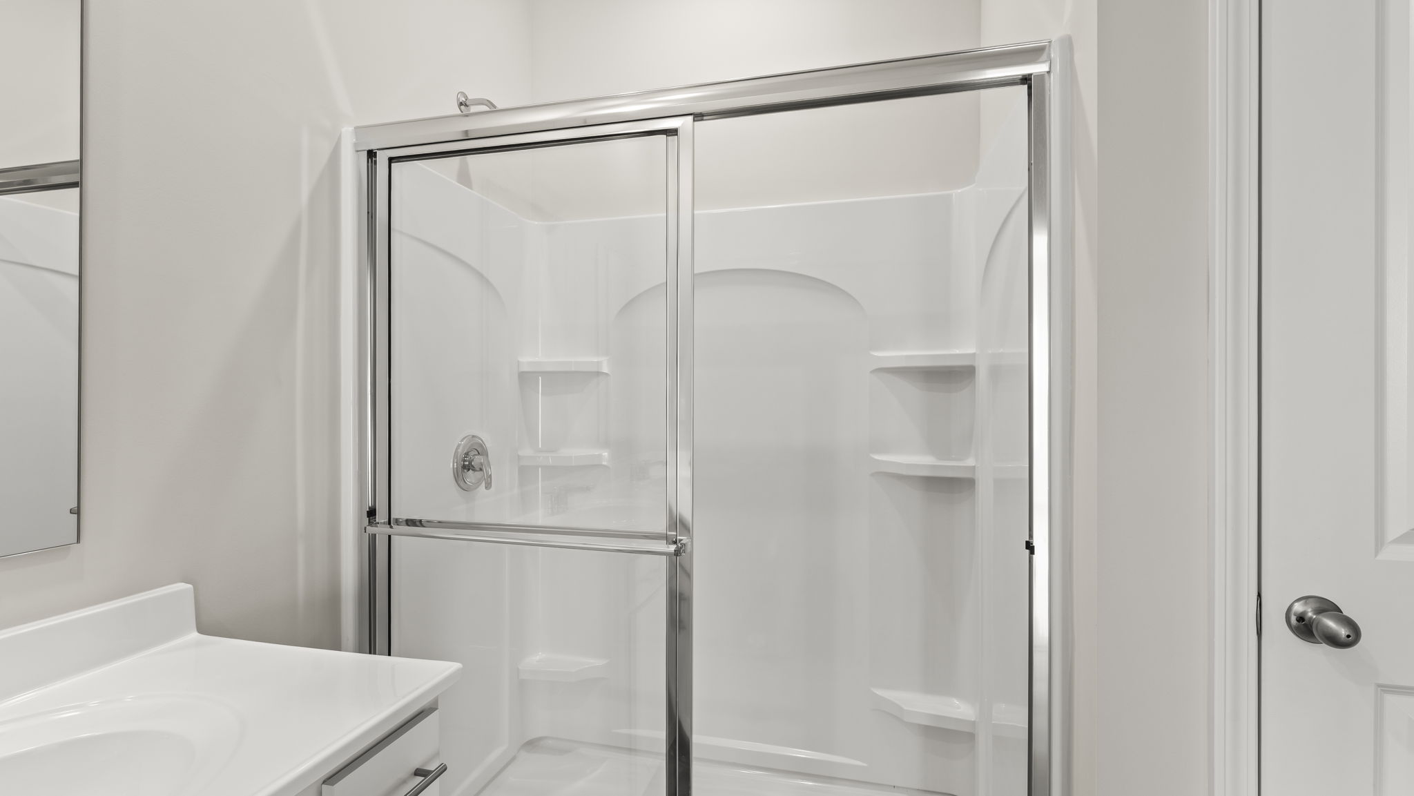 Closeup of walk-in shower with shelving