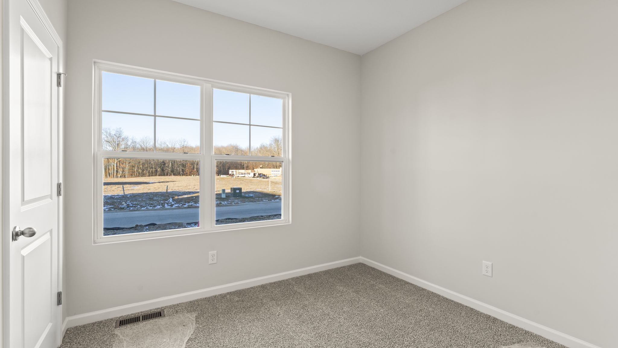 Carpeted bedroom with window