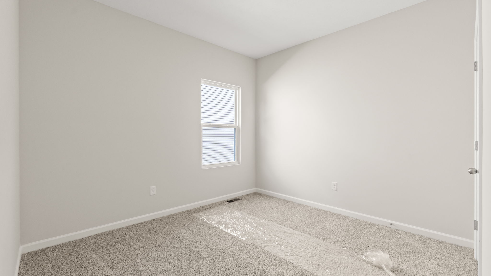 carpeted bedroom with window