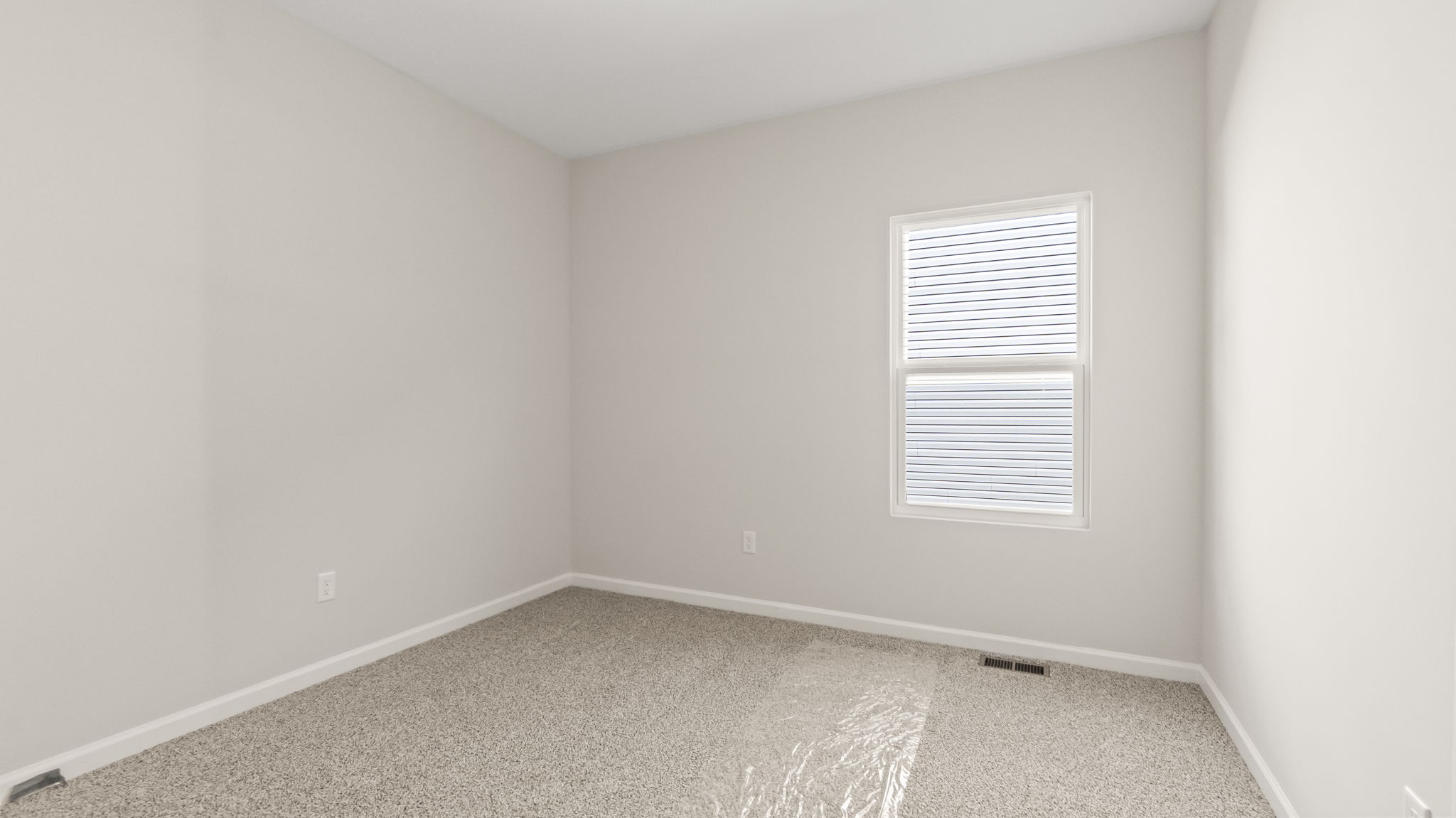 carpeted bedroom with window