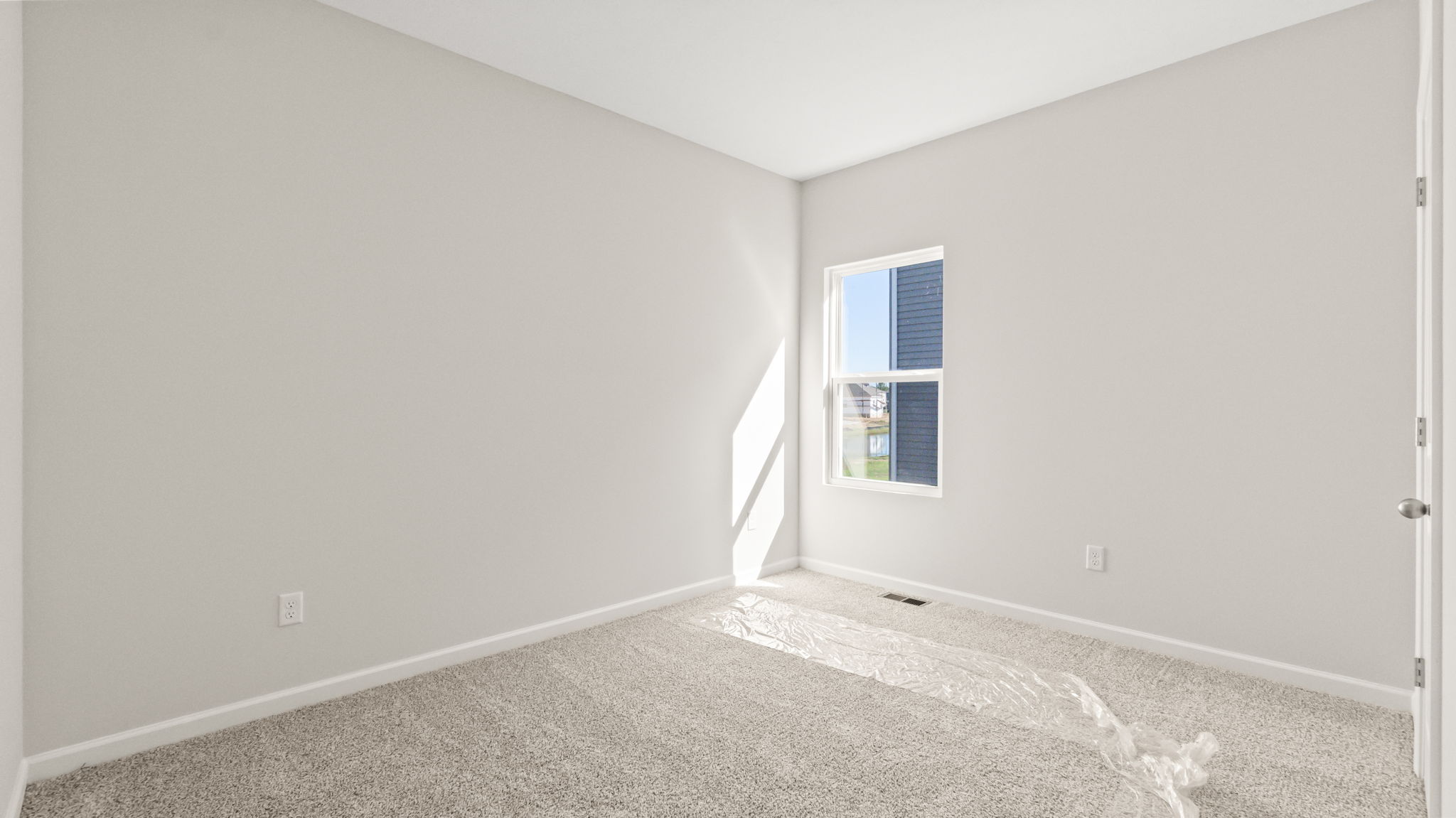 carpeted bedroom with window