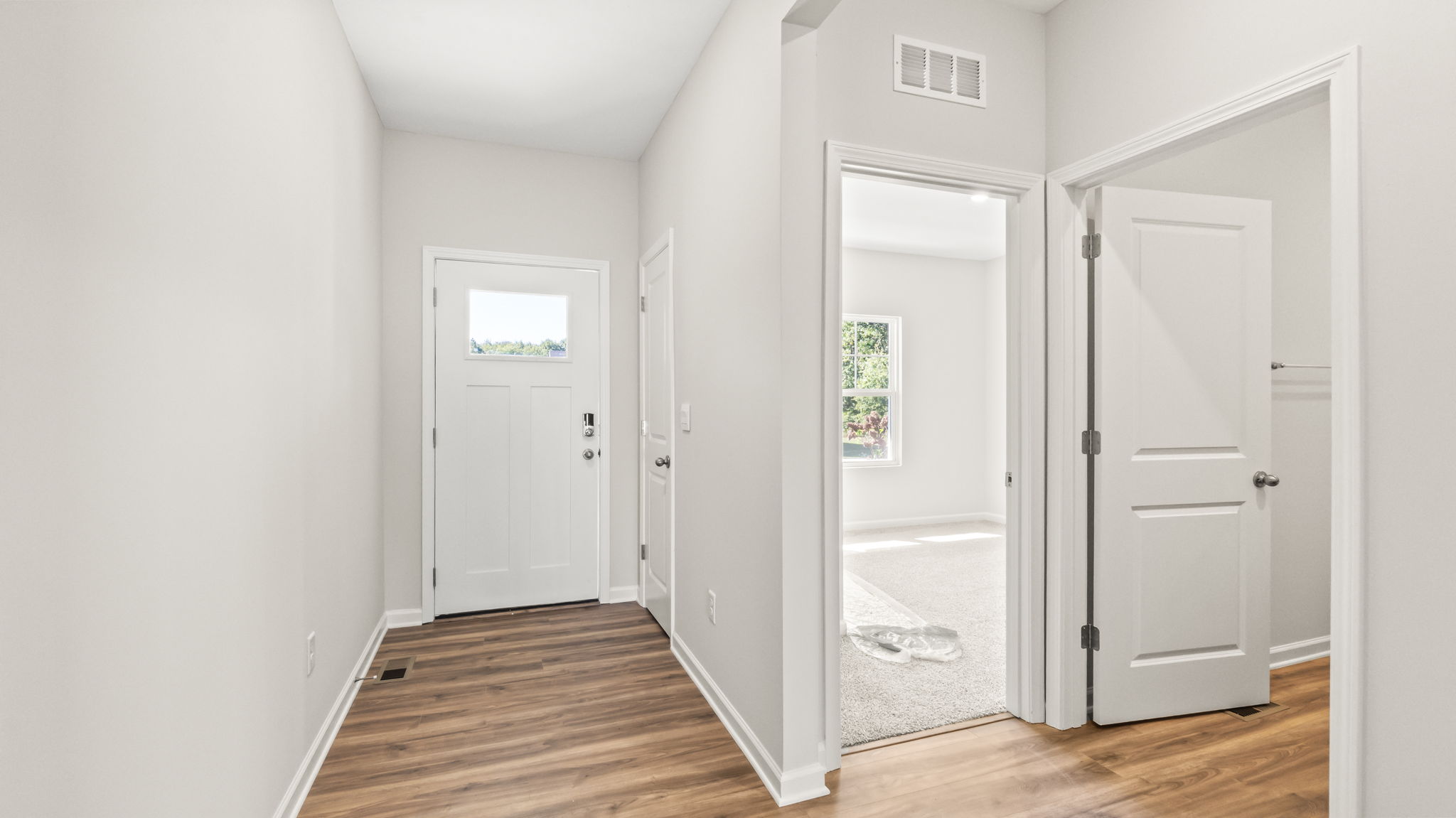 hallway leading to front door and bedroom