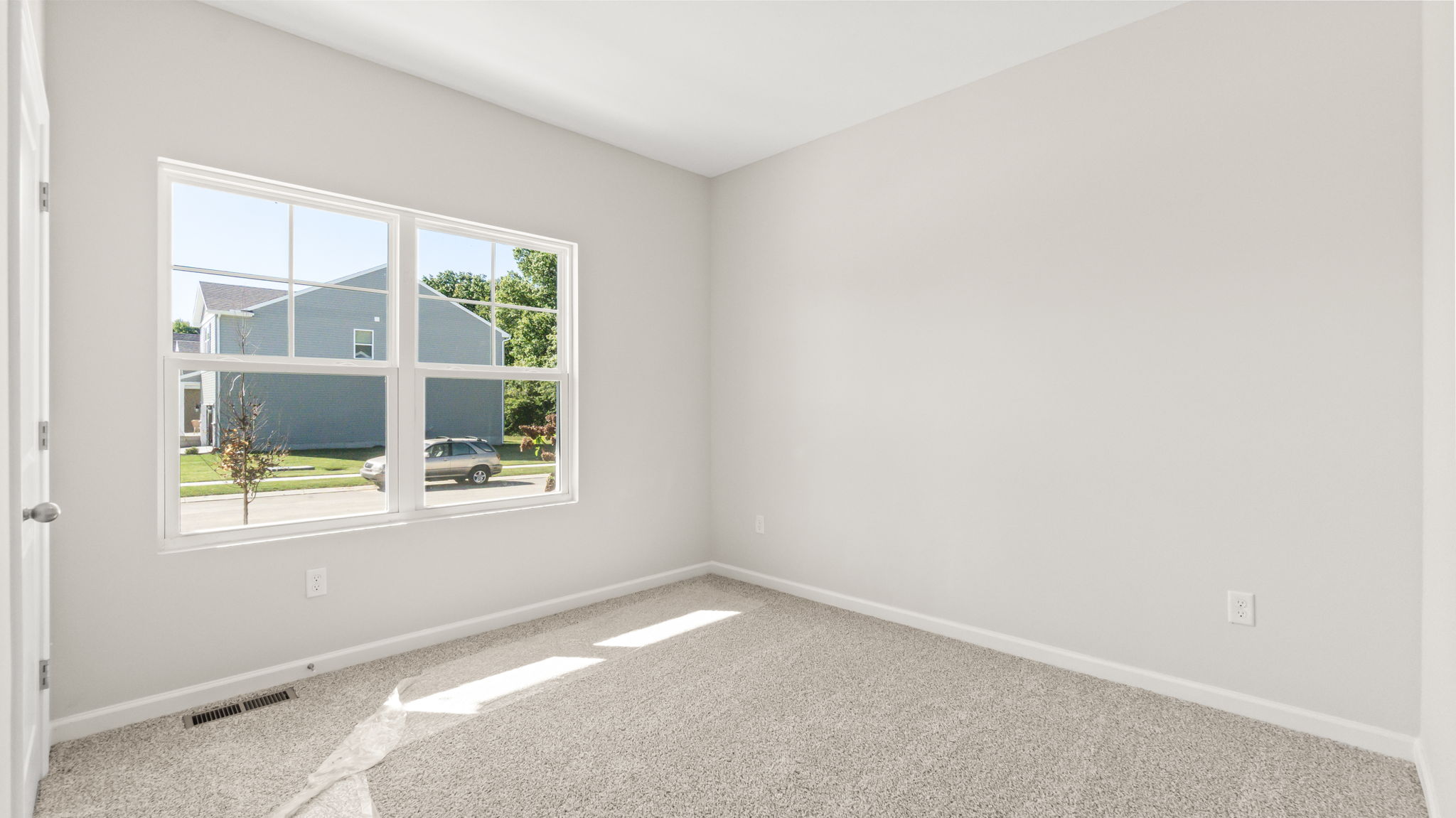 carpeted bedroom with window