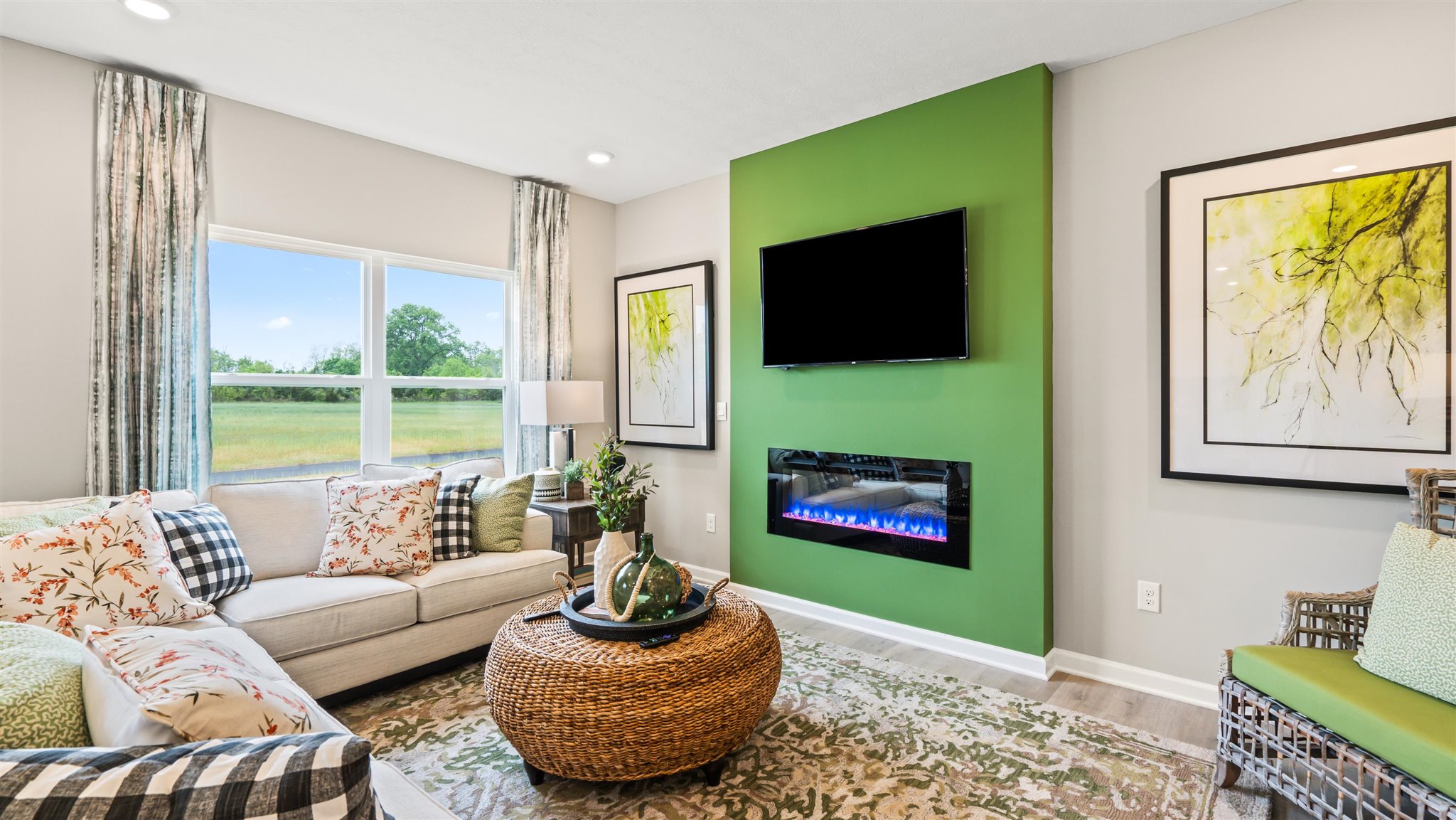 Living room with modern green art décor and wicker coffee table.