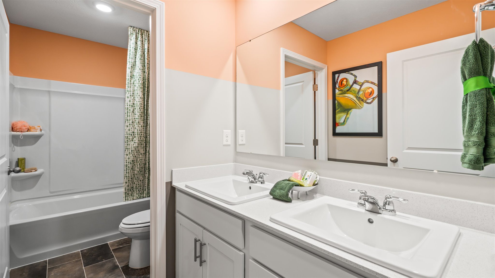 Shared bathroom with dual vanity sink and private bathroom or shower room.