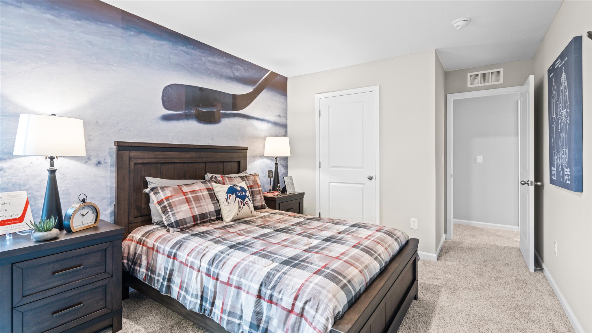 Bedroom 4 with side view of bed and view of hallway.