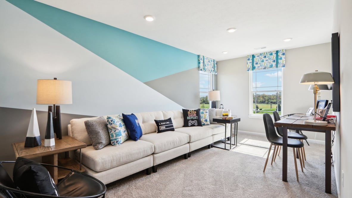 Upstairs landing arranged as a living space with couch and chairs