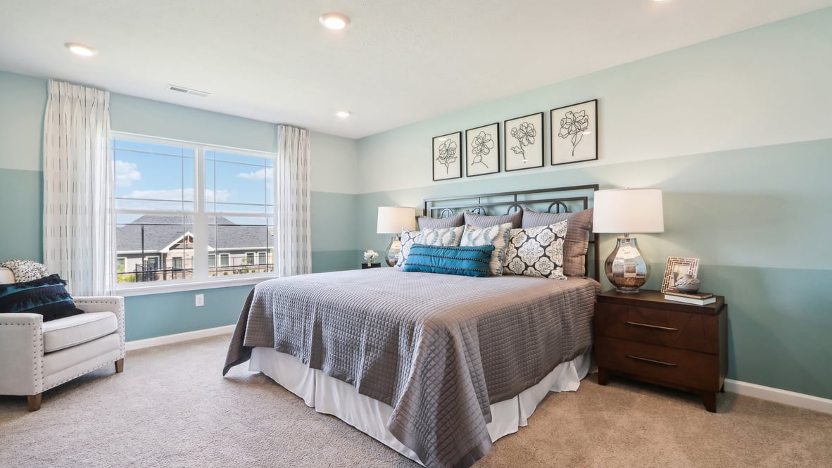 Primary bedroom with blue and grey color scheme