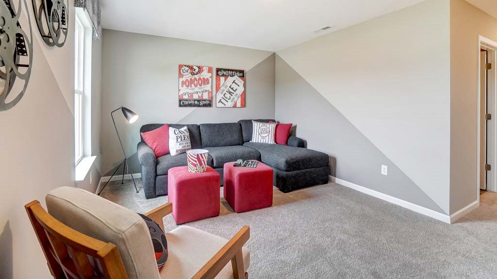 View of loft with movie themed decorations and cozy couch.