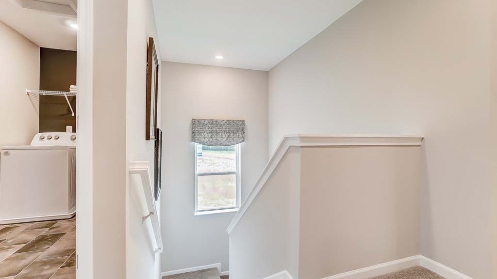 Top of stairs and small view of laundry room.