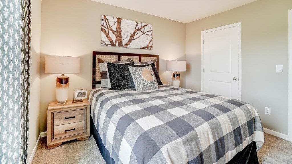 Bedroom with outdoorsy theme with large bed and corner of bed.