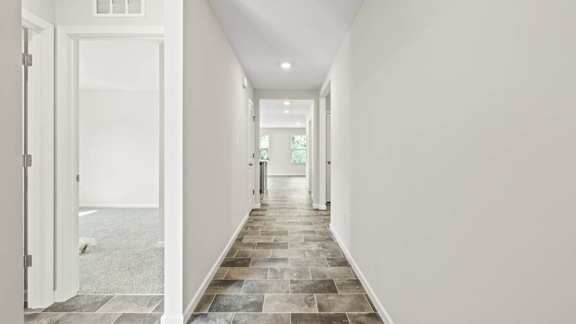 Hallway looking into bedroom and kitchen