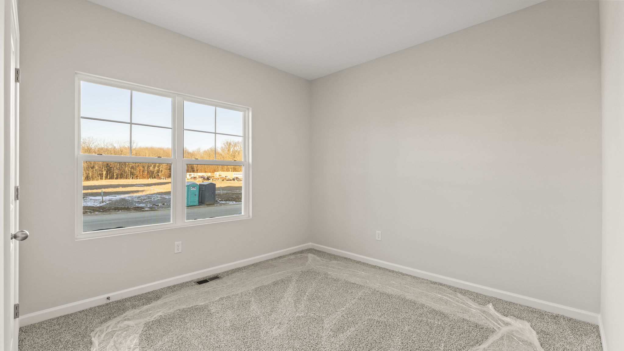 Carpeted bedroom with windows