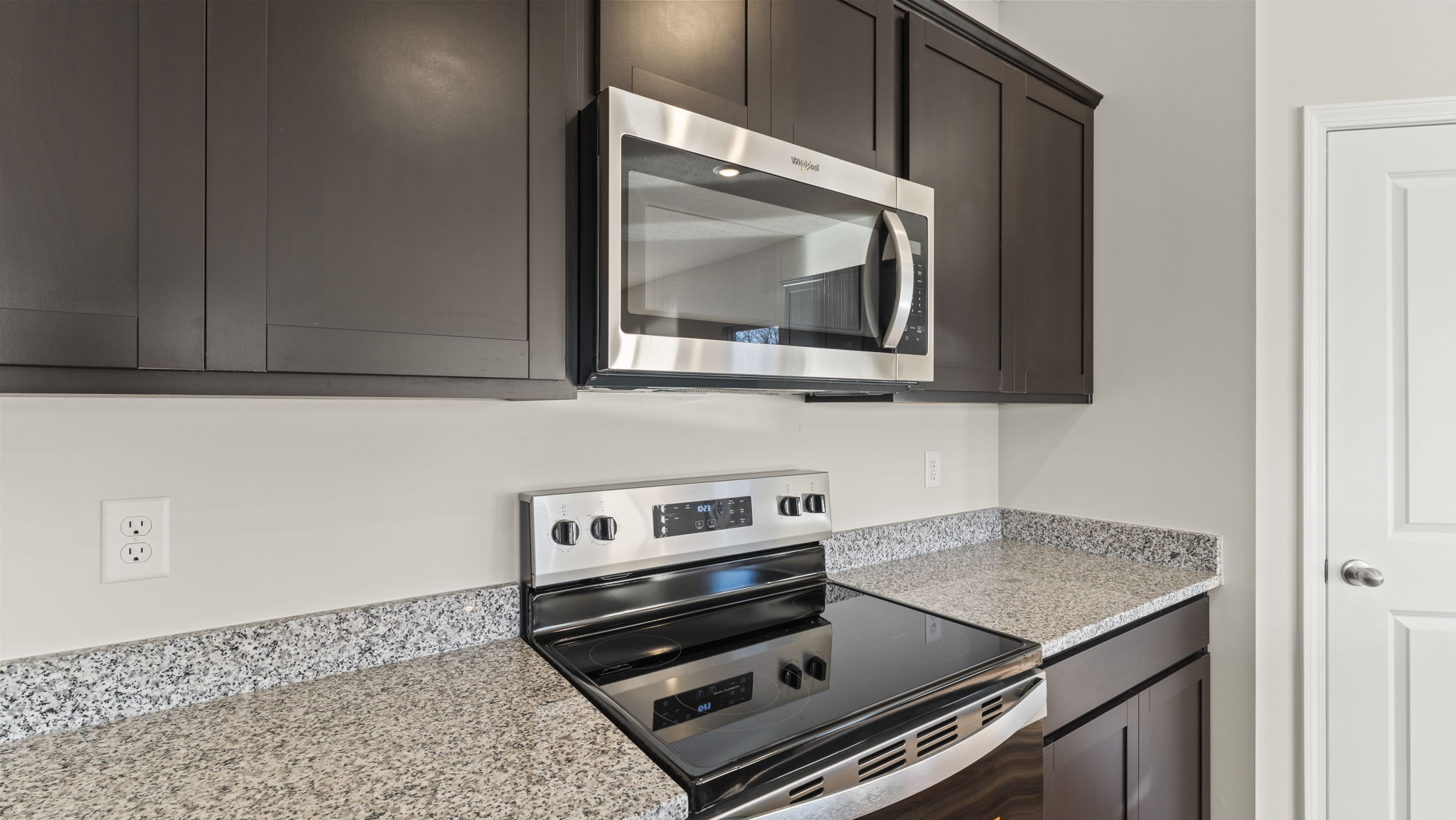 Closeup of oven range between granite countertops