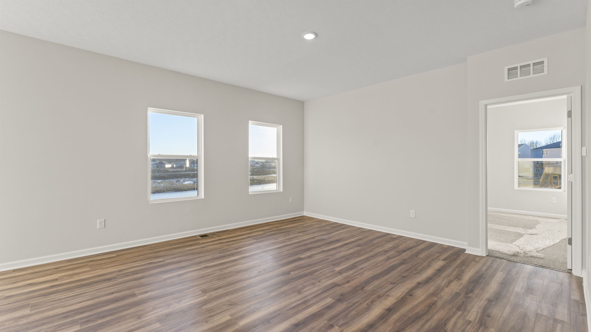Living room with primary bedroom door next to it
