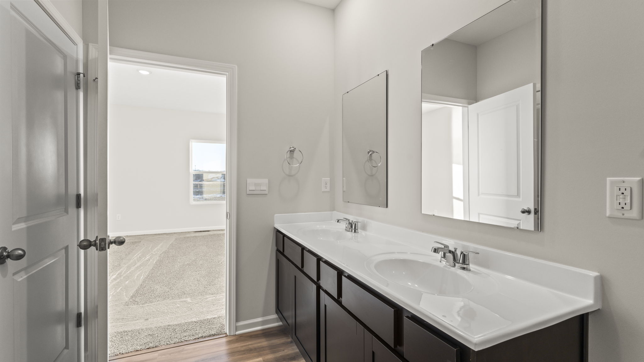 Dual-sink vanity and mirrors in primary bathroom.