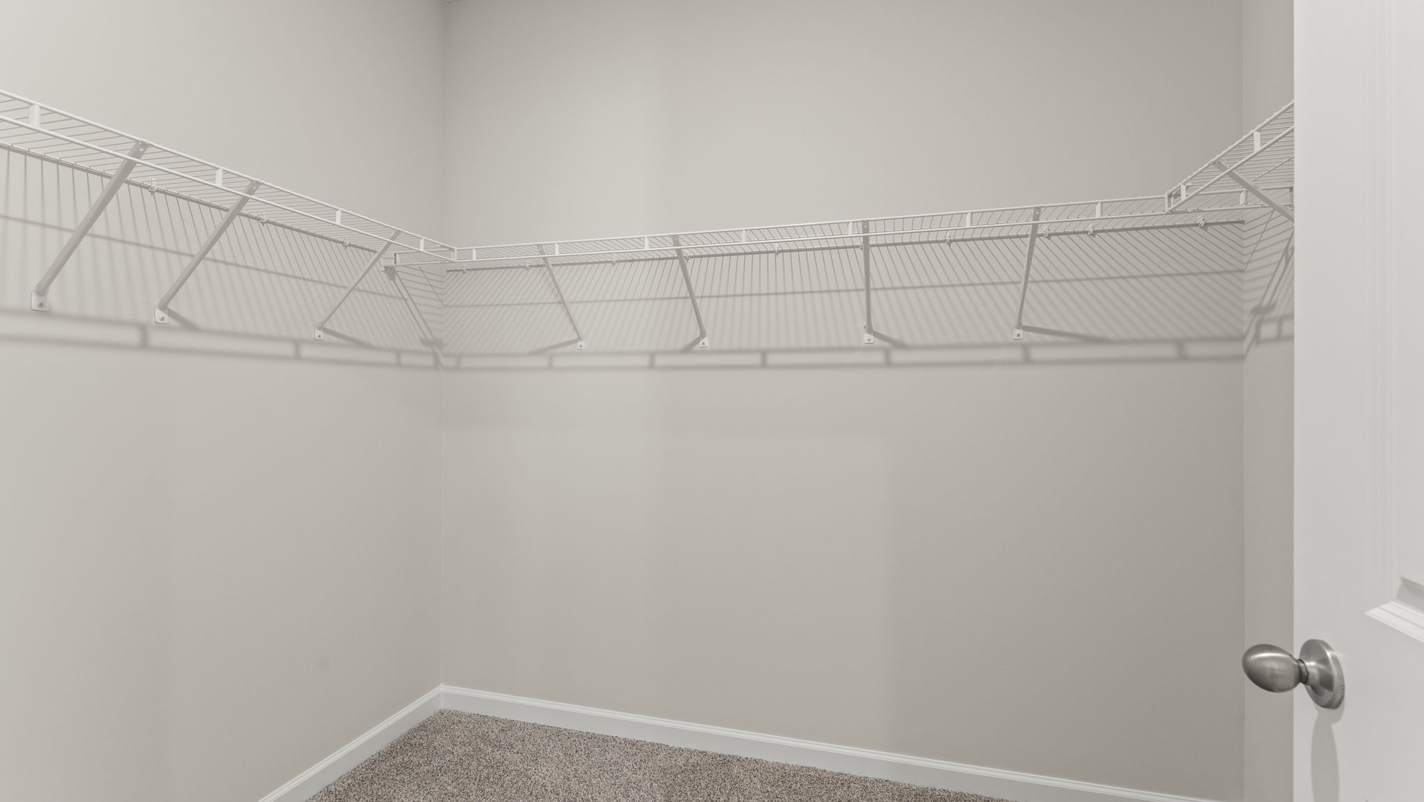 Walk-in closet with wire rack shelving.