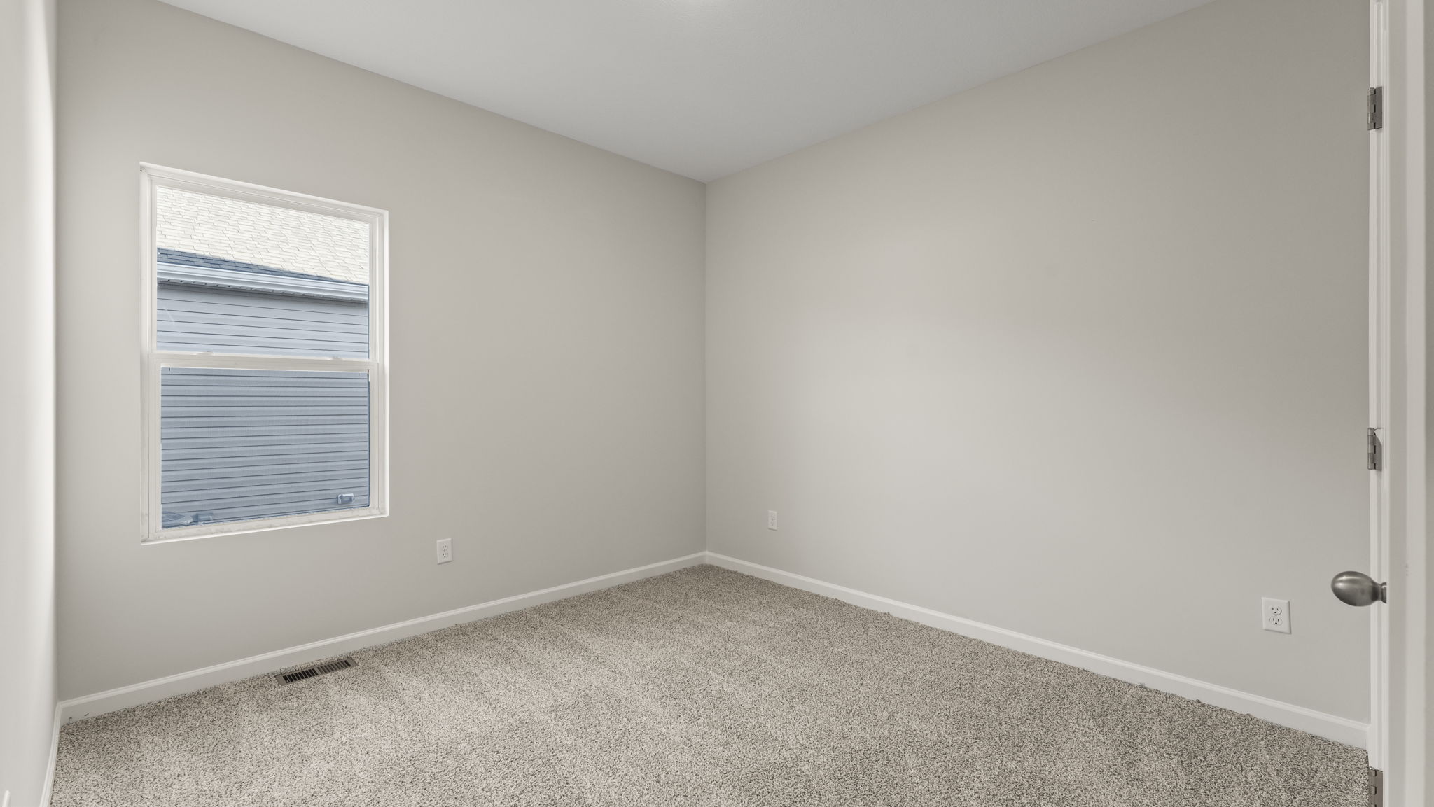Carpeted bedroom with windows