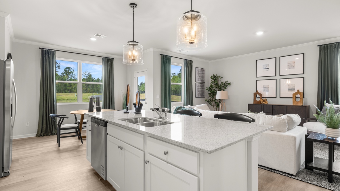 Wide angle image of a modern open-concept plan home from behind the kitchen island