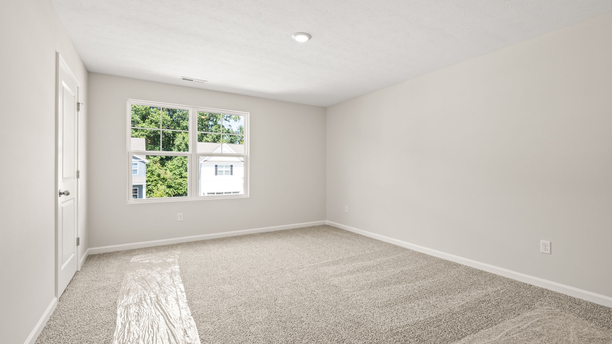 Carpeted bedroom with window