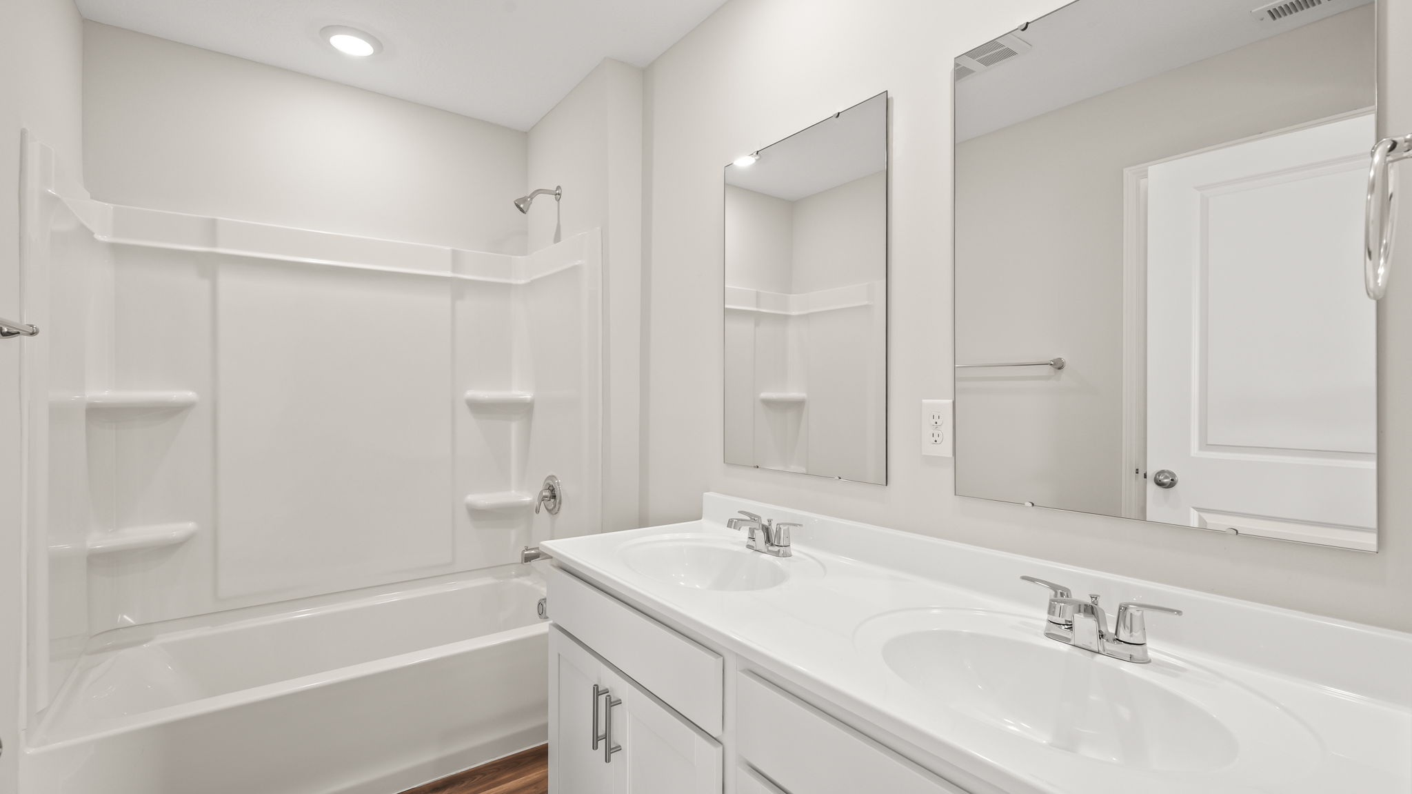 Bathroom with double sink vanity and tub