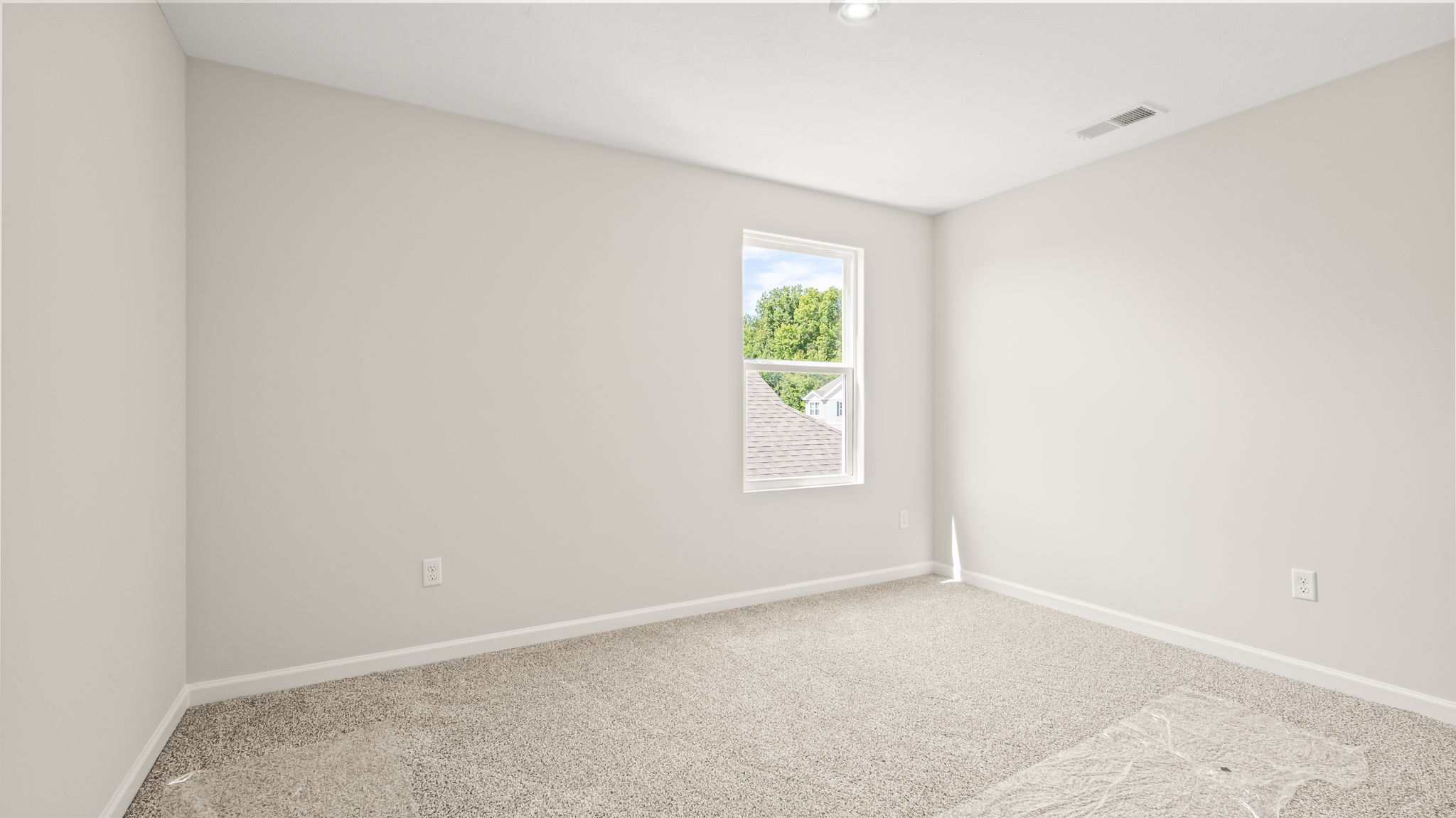 Carpeted bedroom with window