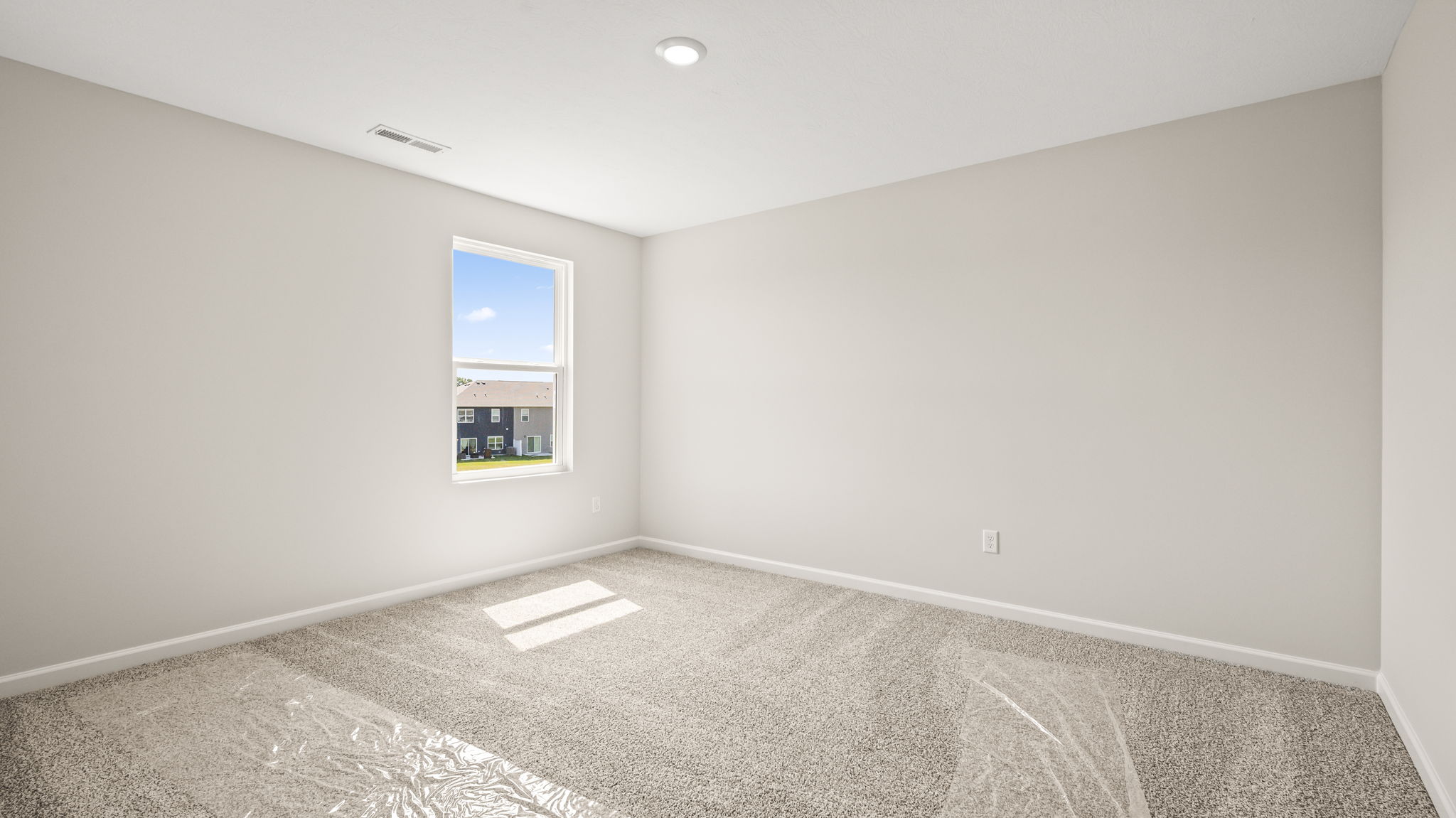 Carpeted bedroom with window