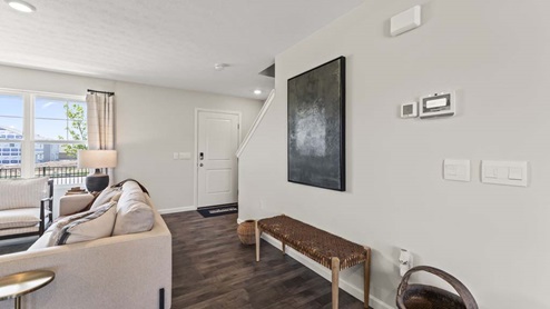 Open living room with brown flooring.