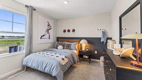 Bedroom with a large window for natural lighting.