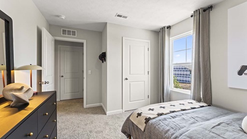 Bedroom with a closet and carpeted floors.