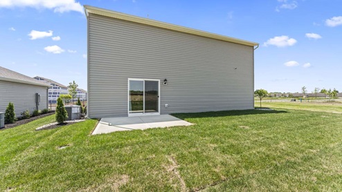 Rear exterior of home with concrete back porch.