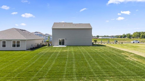 Spacious backyard with luscious grass.