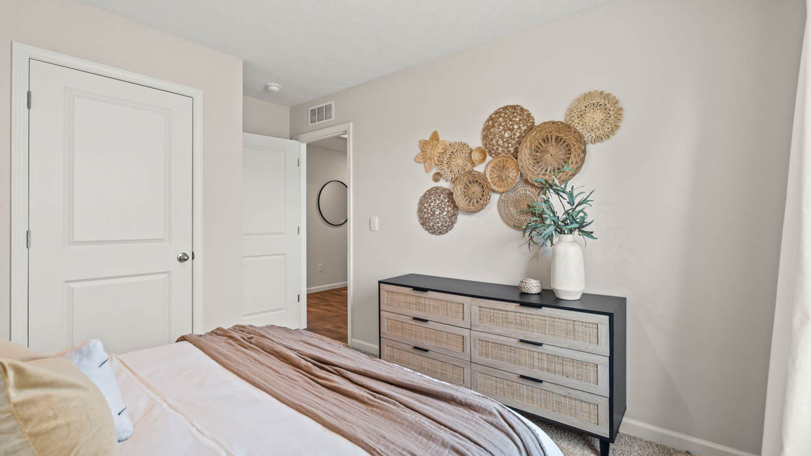 Bedroom with fabric style decorations and hallway to foyer.