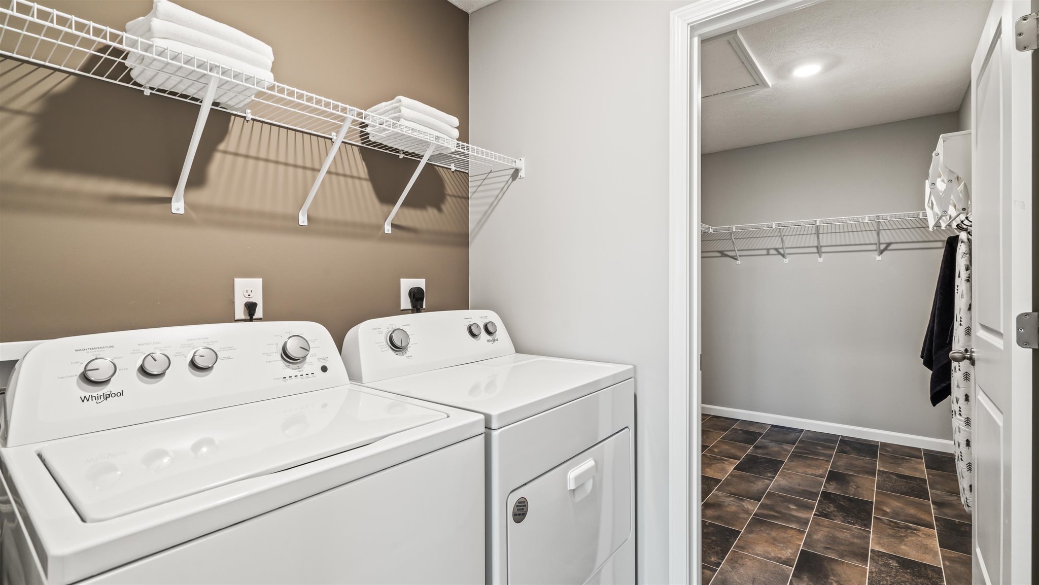 Laundry room with extra storage room or mech room.