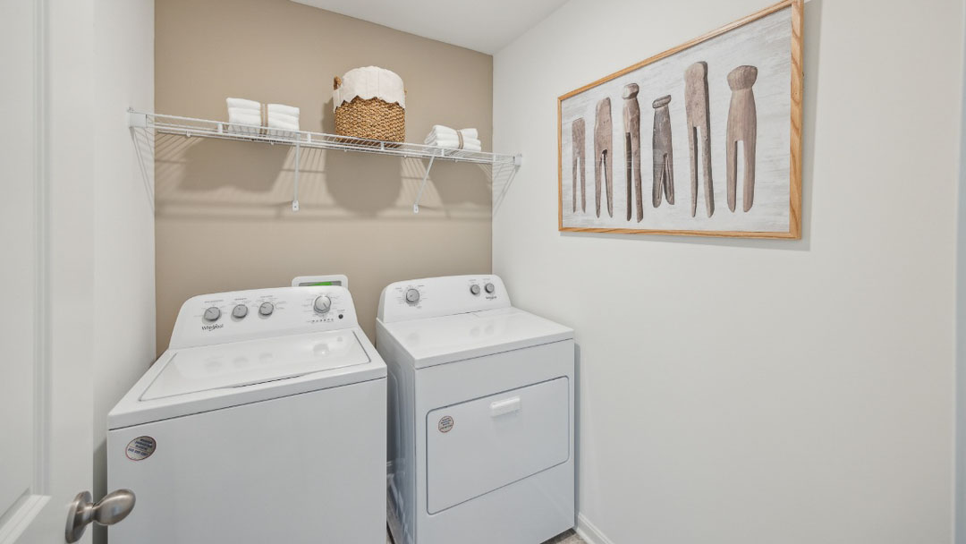 spacious laundry room with side by side washer and dryer