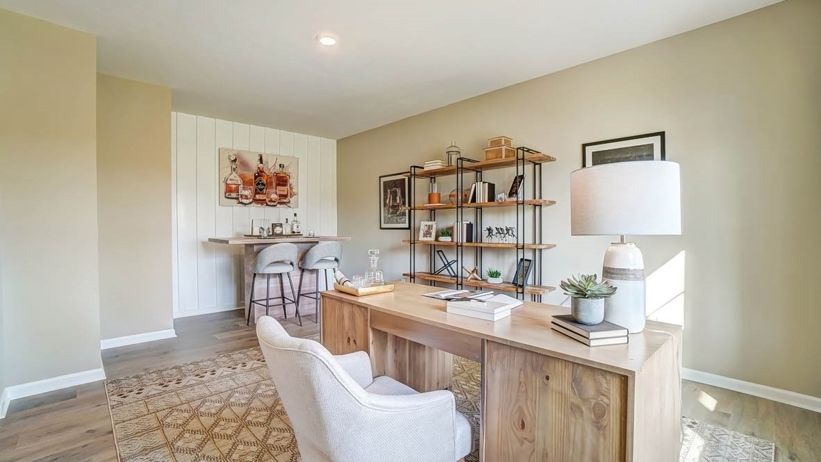 Office with large desk space and bar area.