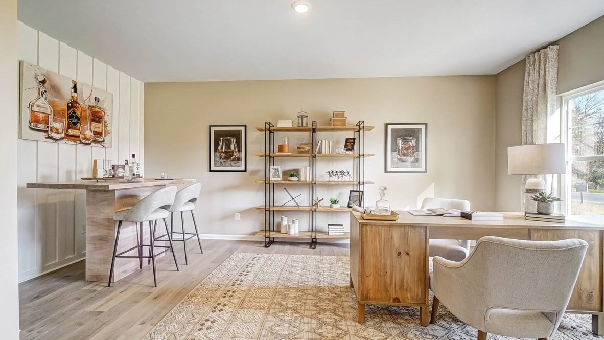 Full Office with wooden desk and personal bar on the left.