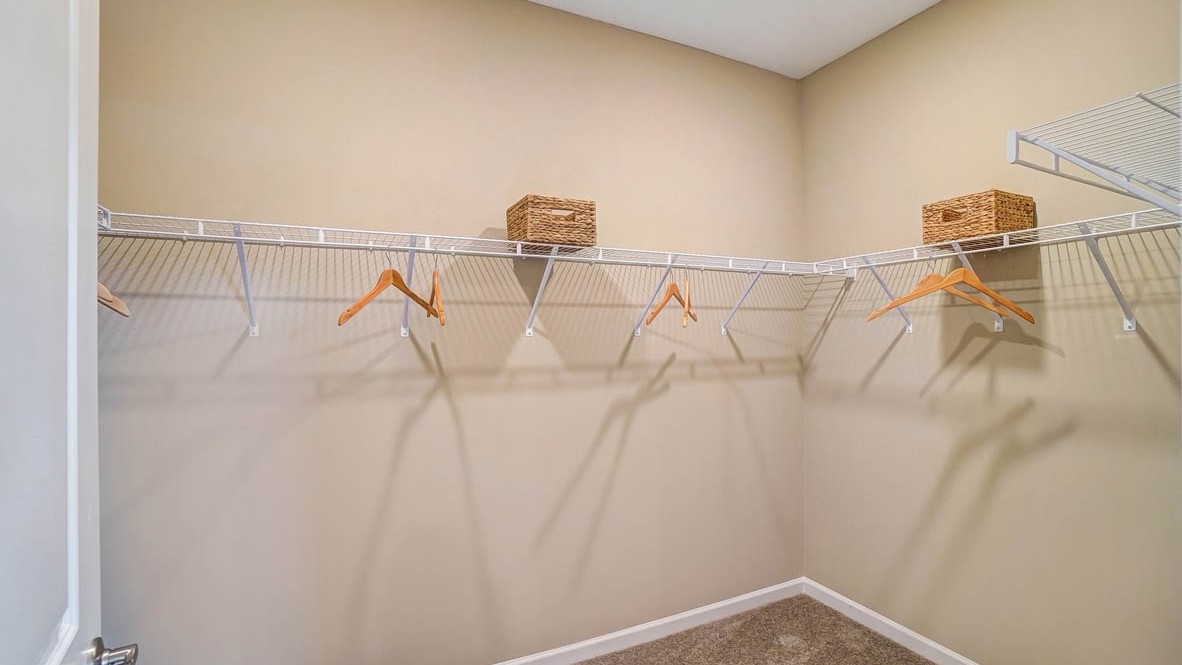 walkin closet with amble storage shelving and space.