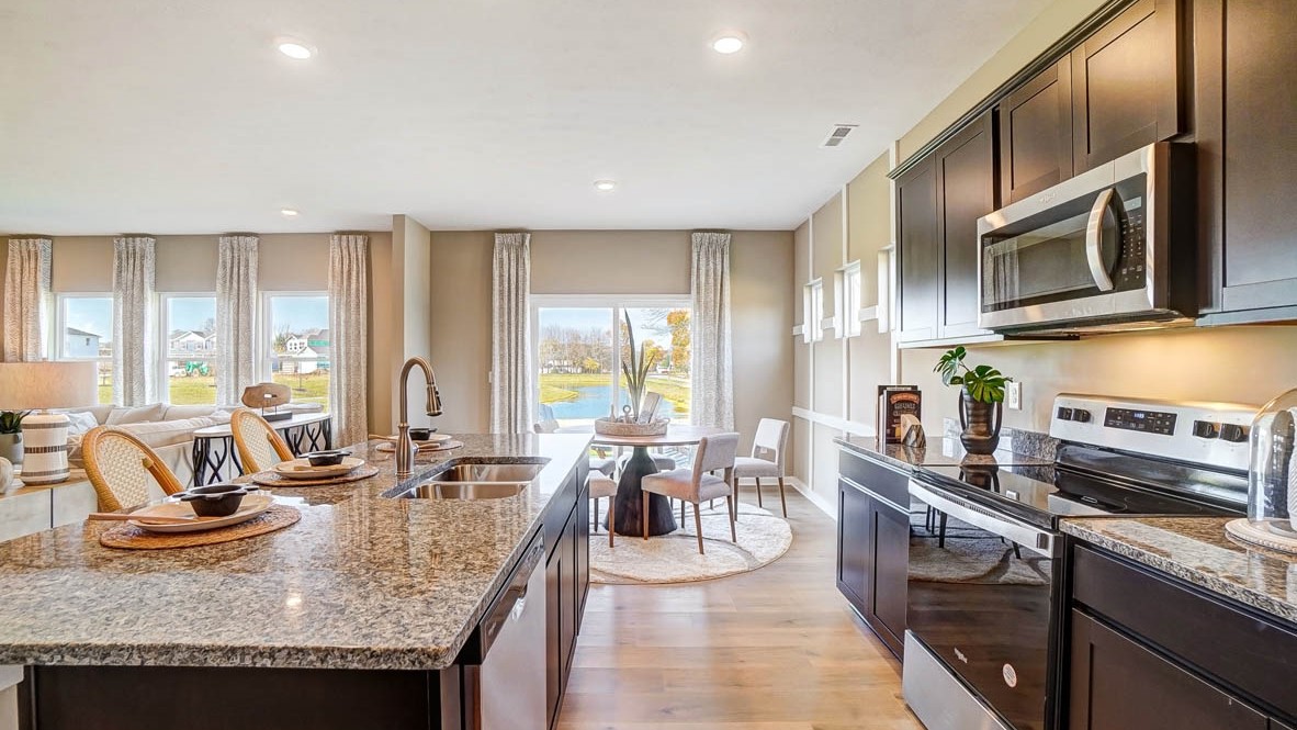 Open concept kitchen and dining room looking out to backyard