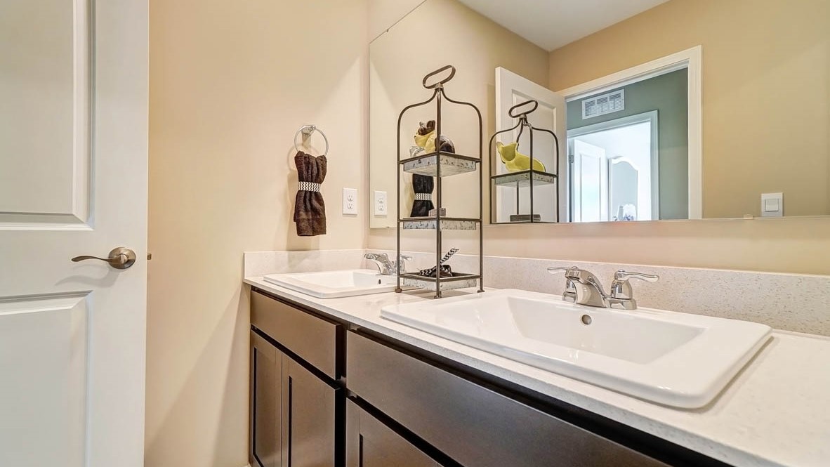granite countertops with dual vanity sinks and large mirror.