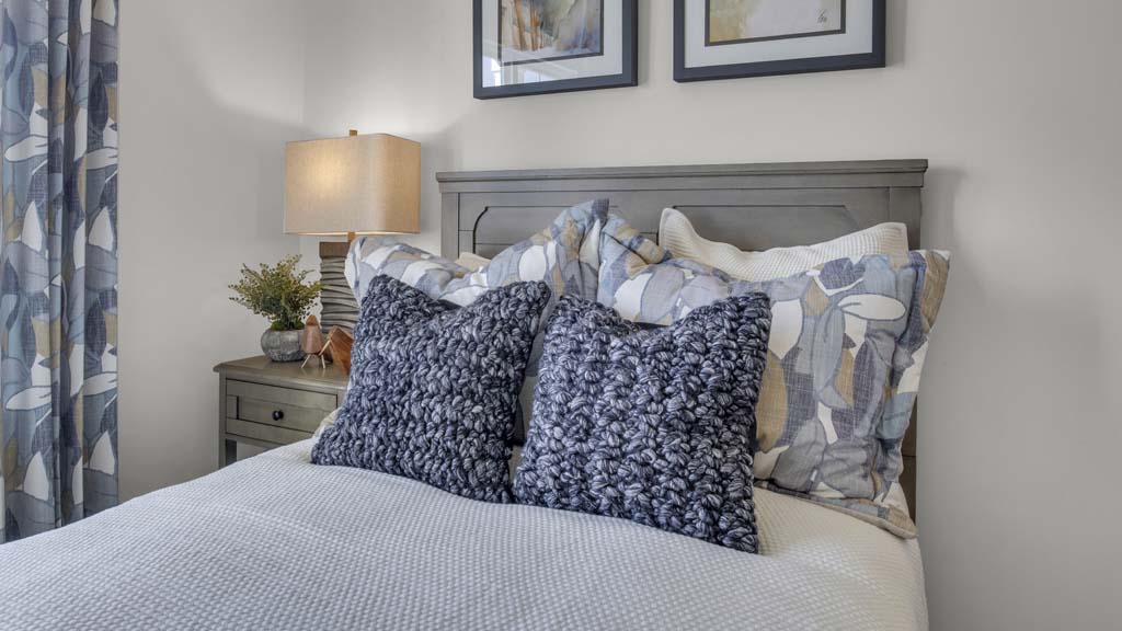 Close up on front bedroom pillows and side table.