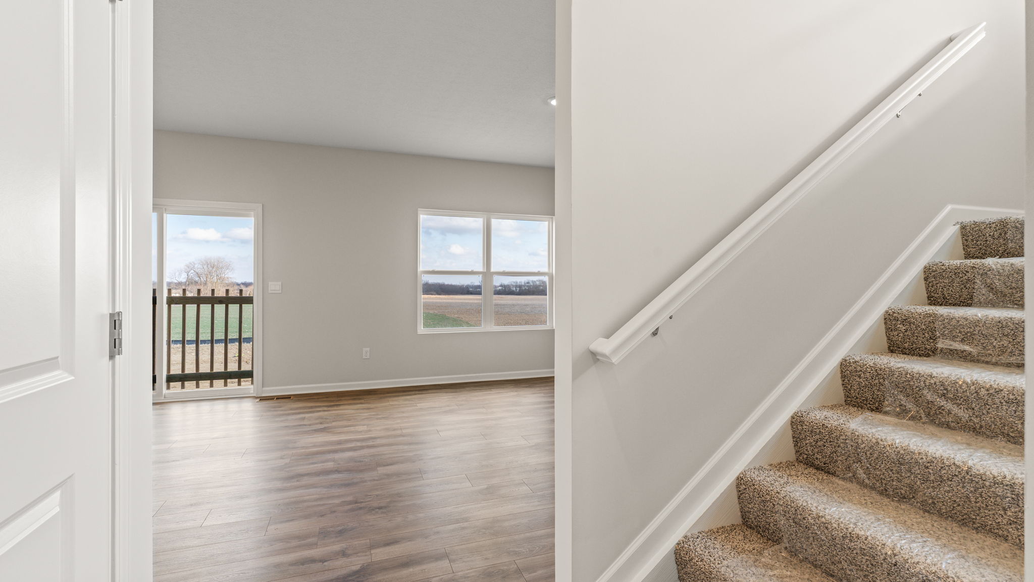 Foyer with great area on the left and stairs on the right.