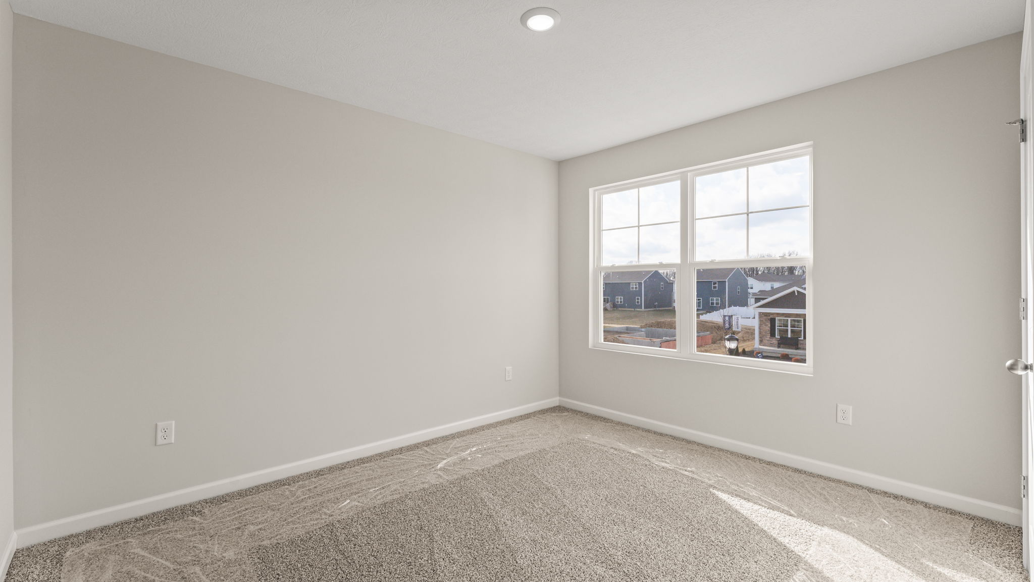 Carpeted bedroom with window