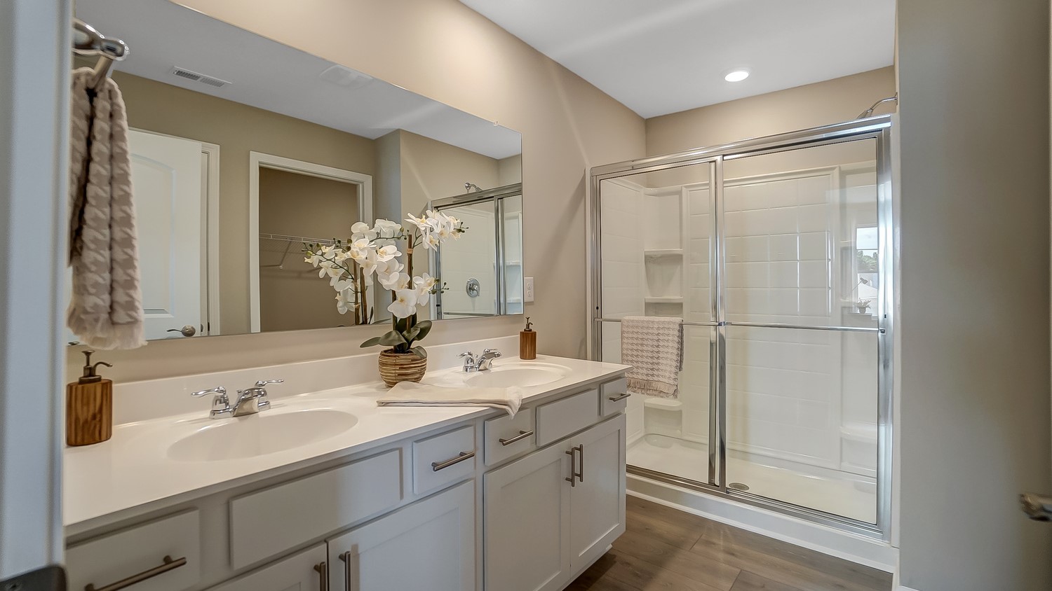 Primary Bathroom with dual vanity sinks and shower.